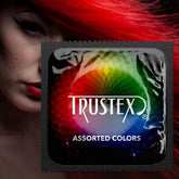 A close-up of a Trustex Assorted Colors Lubricated Condoms wrapper, featuring a colorful spiral design and the brand name "Trustex." In the background, a person with red hair and bold makeup is partially visible, emphasizing the allure of these condoms.